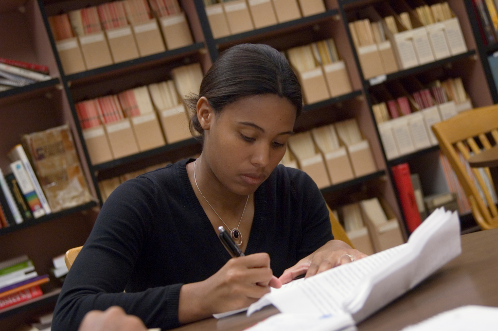 Transfer Credit Appeal Forms image of a young lasy filling out a form. 