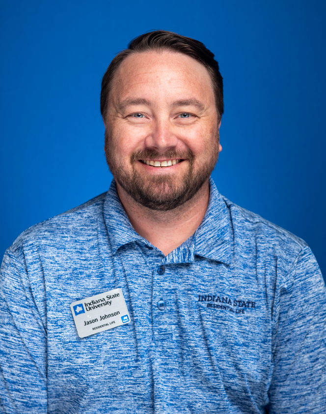 Headshot of an Indiana State University Residential Life staff member wearing a blue polo and name badge against a blue background.
