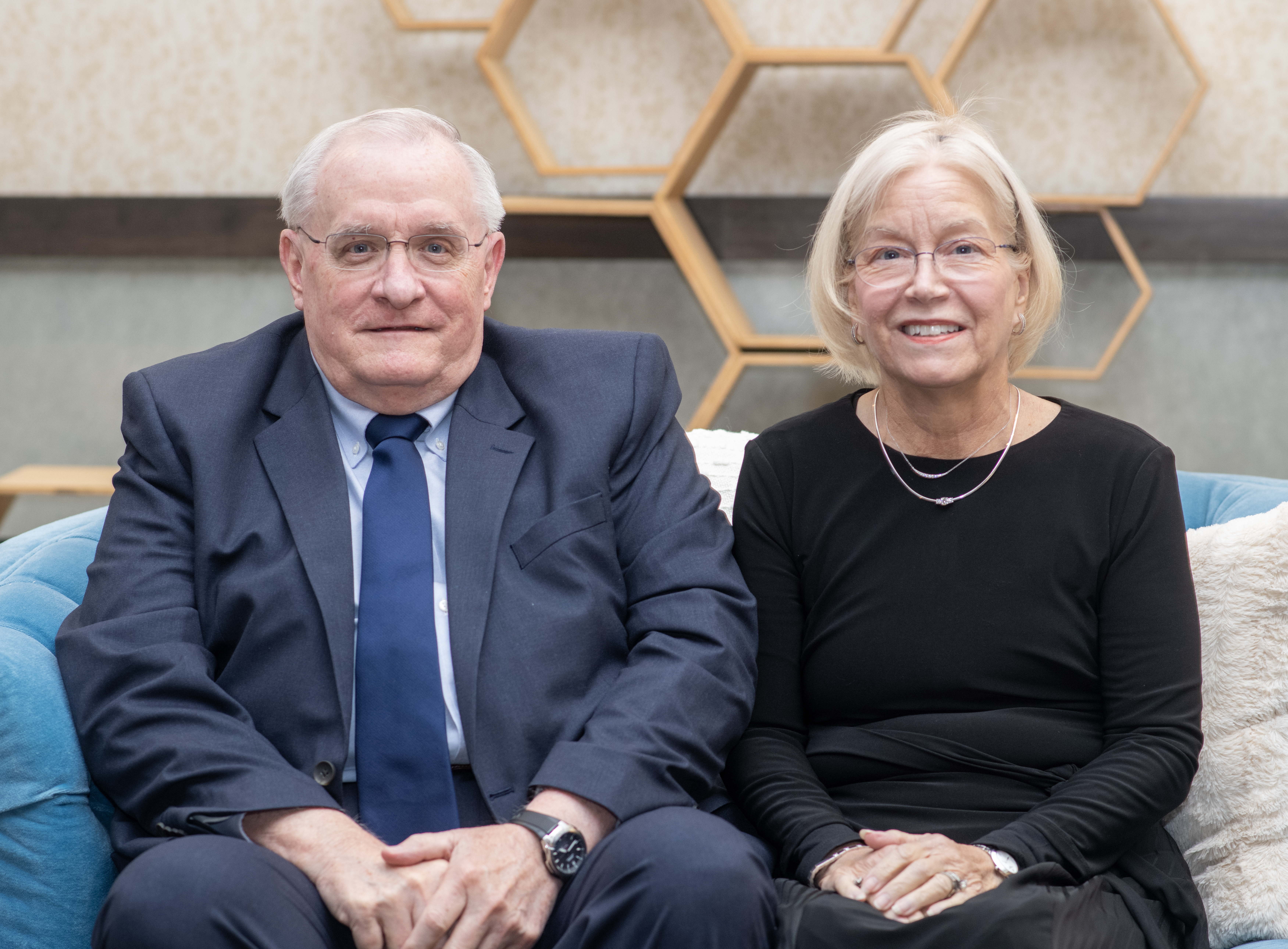 Jerry Cockrell (left) and Jan Cockrell (right) sit side by side on a sofa. 