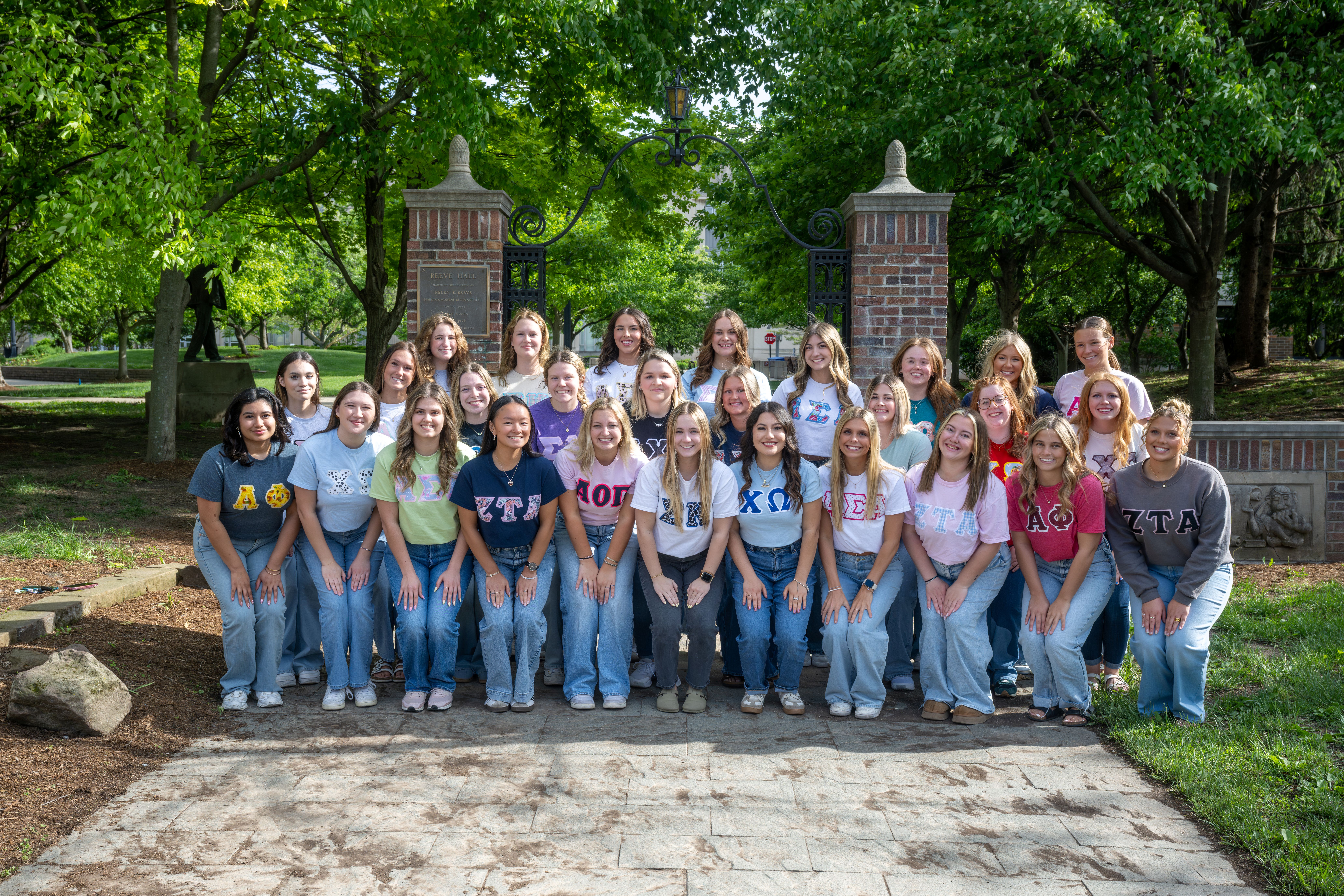 Group photo of the 2026 Panhellenic community in front of the Old Reeve Hall arch.