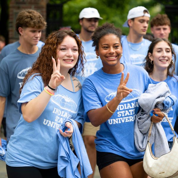 Two students giving the peace sign