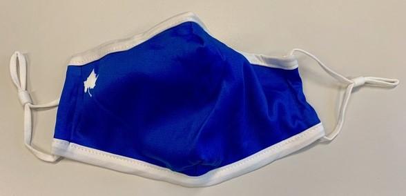 Blue fabric face mask with white trim and a small white maple leaf design on the side, lying flat on a white surface.