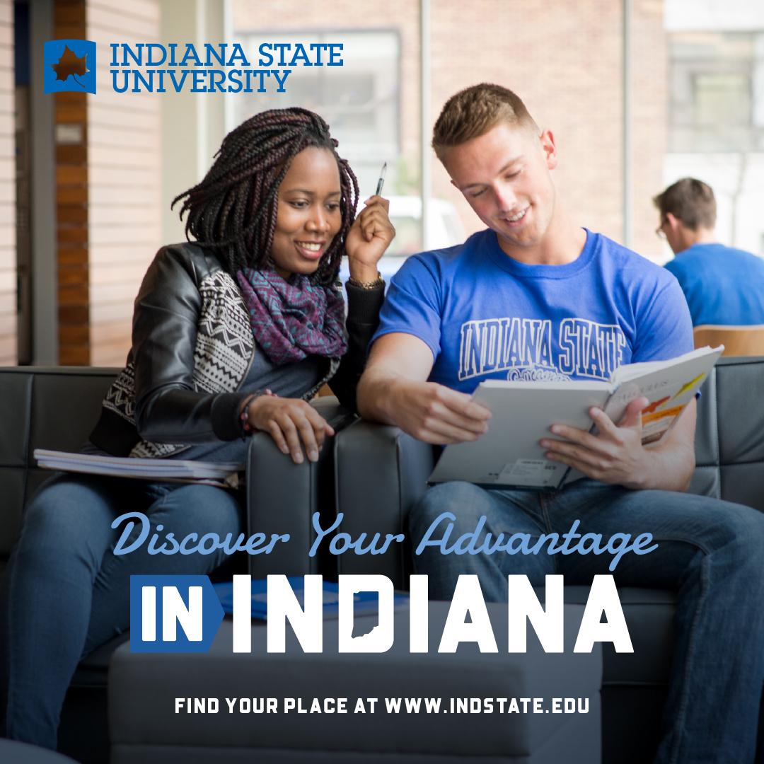 Two students sitting on a couch, one wearing an Indiana State University shirt, looking at a book together. Indiana State University logo and slogan visible.