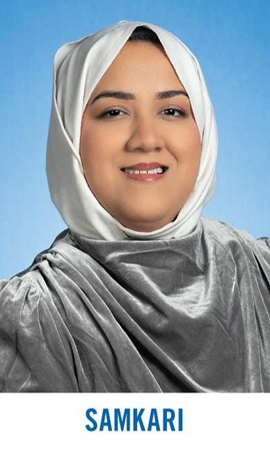 Smiling woman wearing a white headscarf and gray velvet top against a blue background, with the name Samkari below.