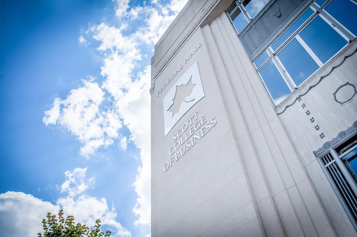 Exterior view of Federal Hall at Scott College of Business with clear blue sky and clouds overhead.